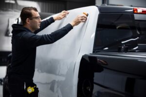 medium-shot-professional-man-wrapping-car_23-2149385702