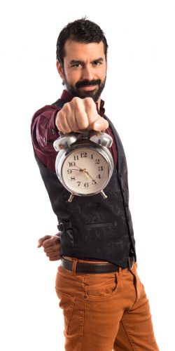 happy-man-wearing-waistcoat-holding-vintage-clock_1368-3222